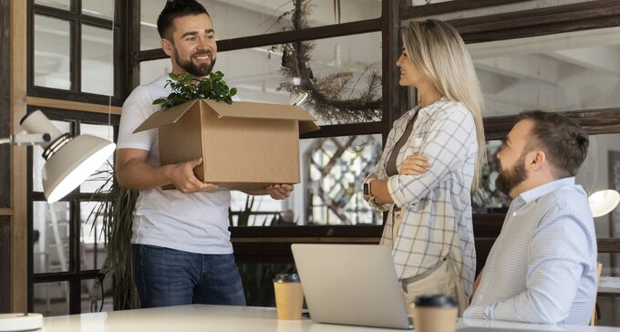  Happy employees communicating with each other in an open office