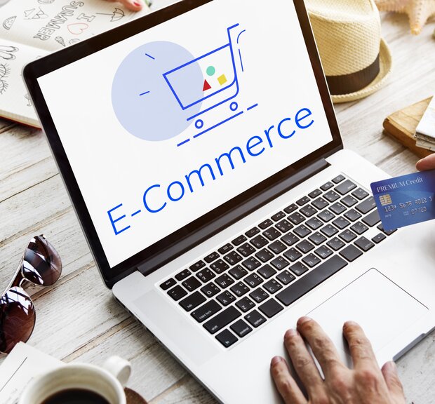  computer screen with a shopping cart icon and credit card, symbolizing e-commerce